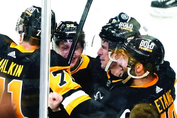 Crosby hits milestone in OT win